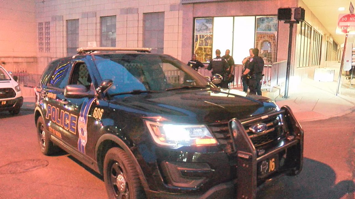 Akron police officers gathered on South High Street as the mayor's overnight curfew went into...