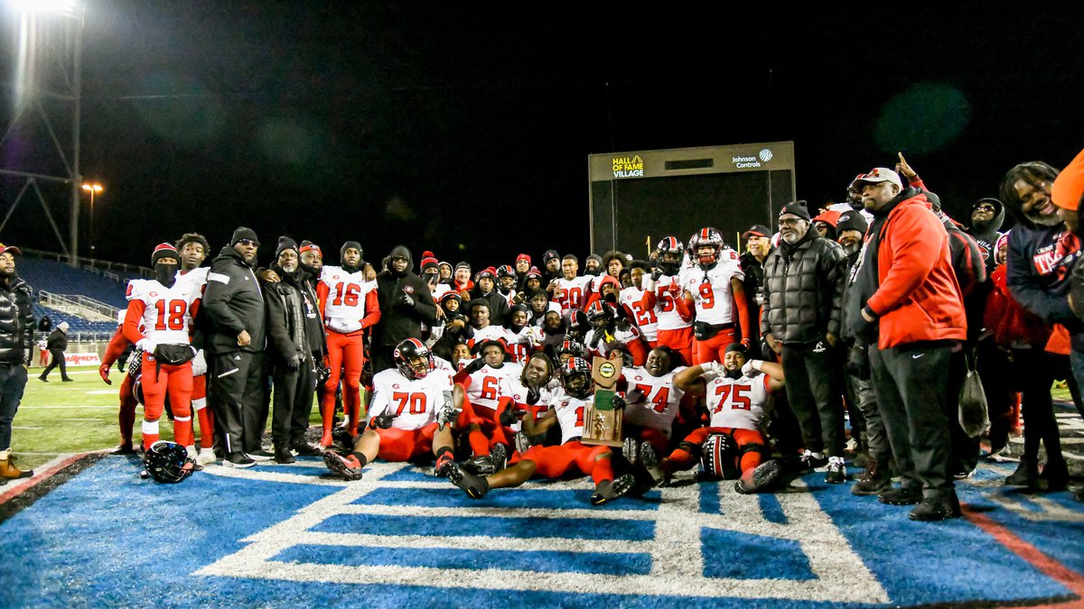 The 2022 Glenville Tarblooders pose with the Division Four State Championship Trophy after...